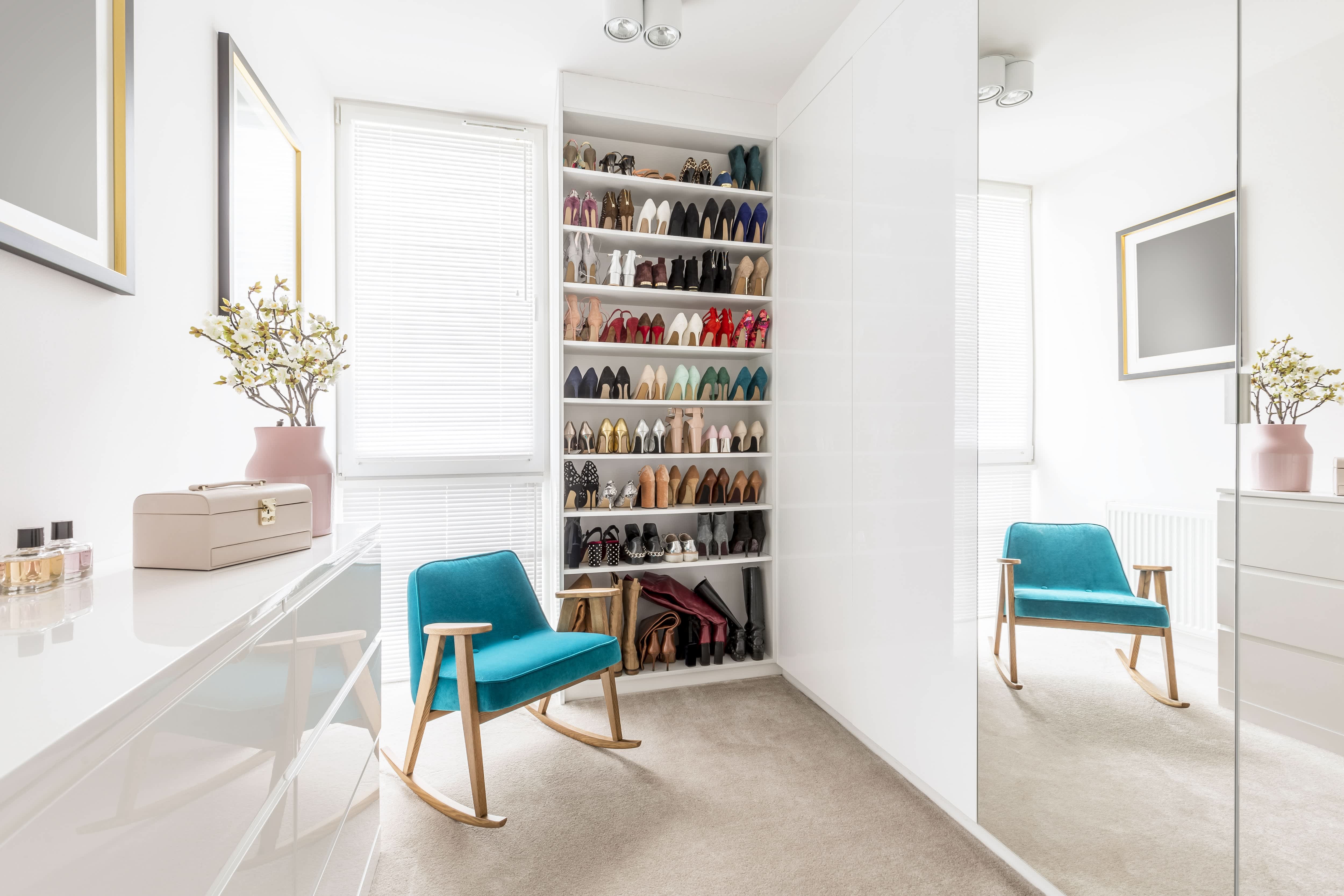A bright, clean wardrobe with a floor to ceiling shoe rack