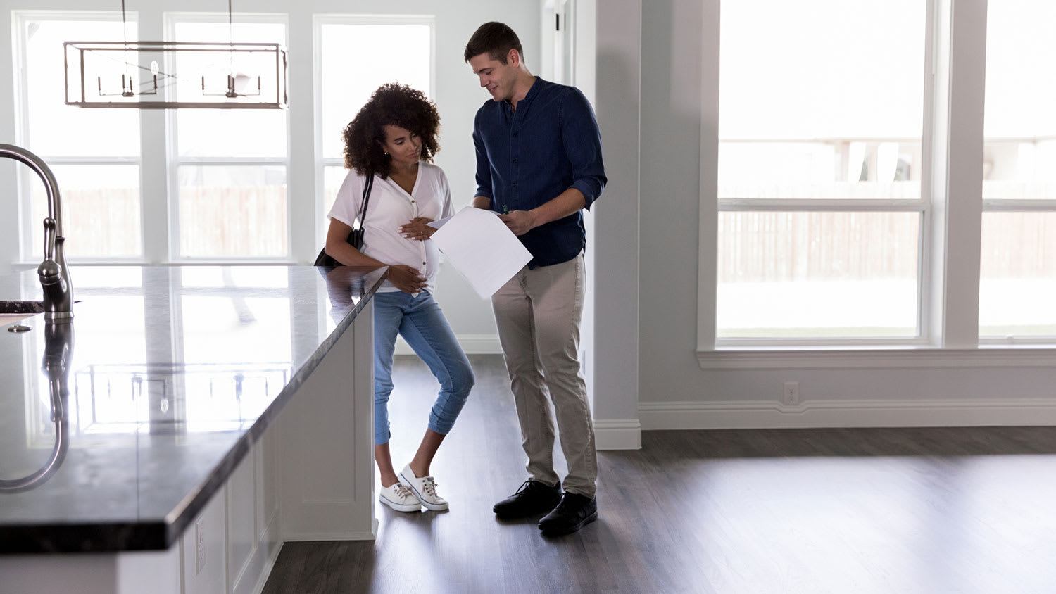 Woman reviewing paperwork in new home