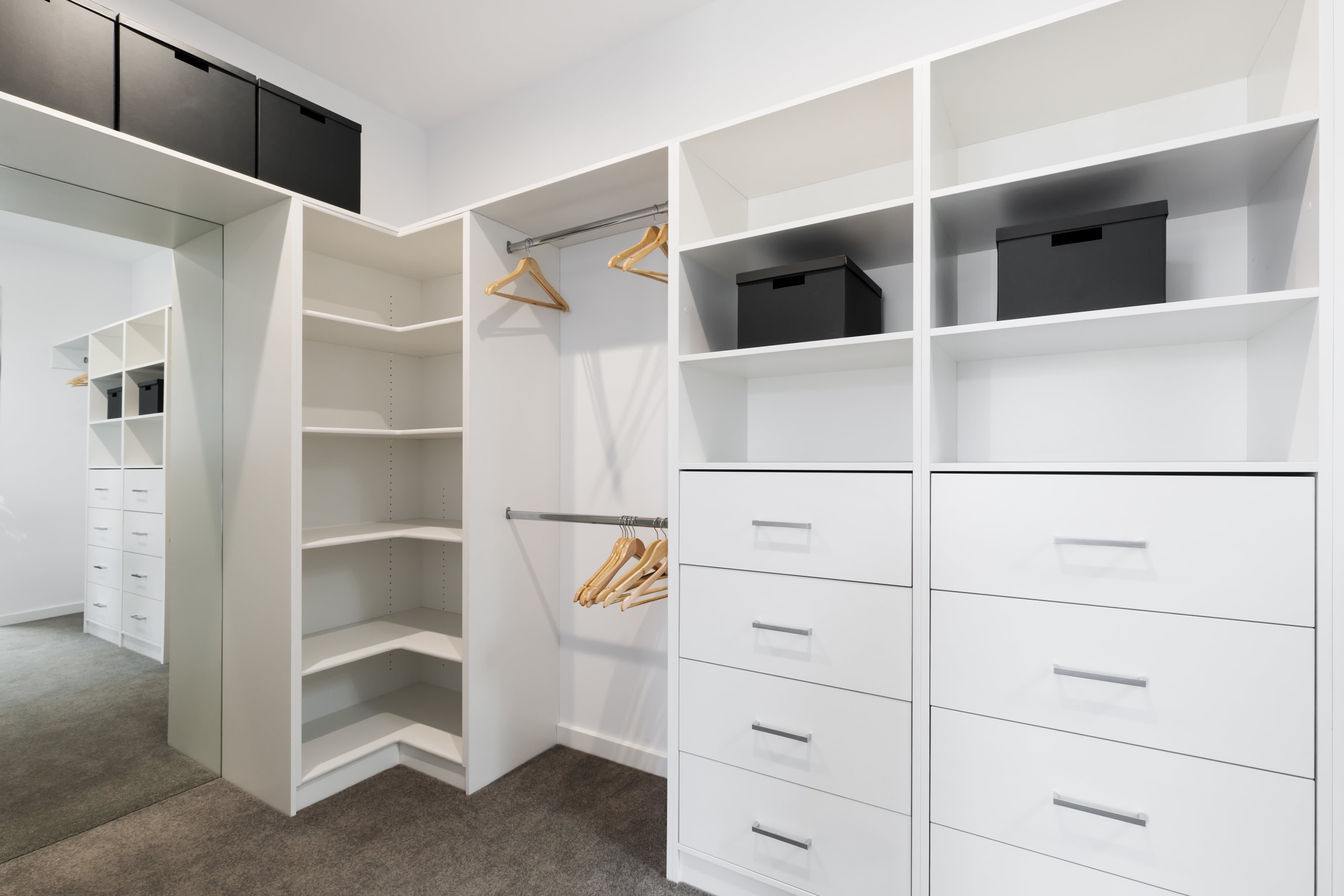 A large walk-in closet with built-in drawers