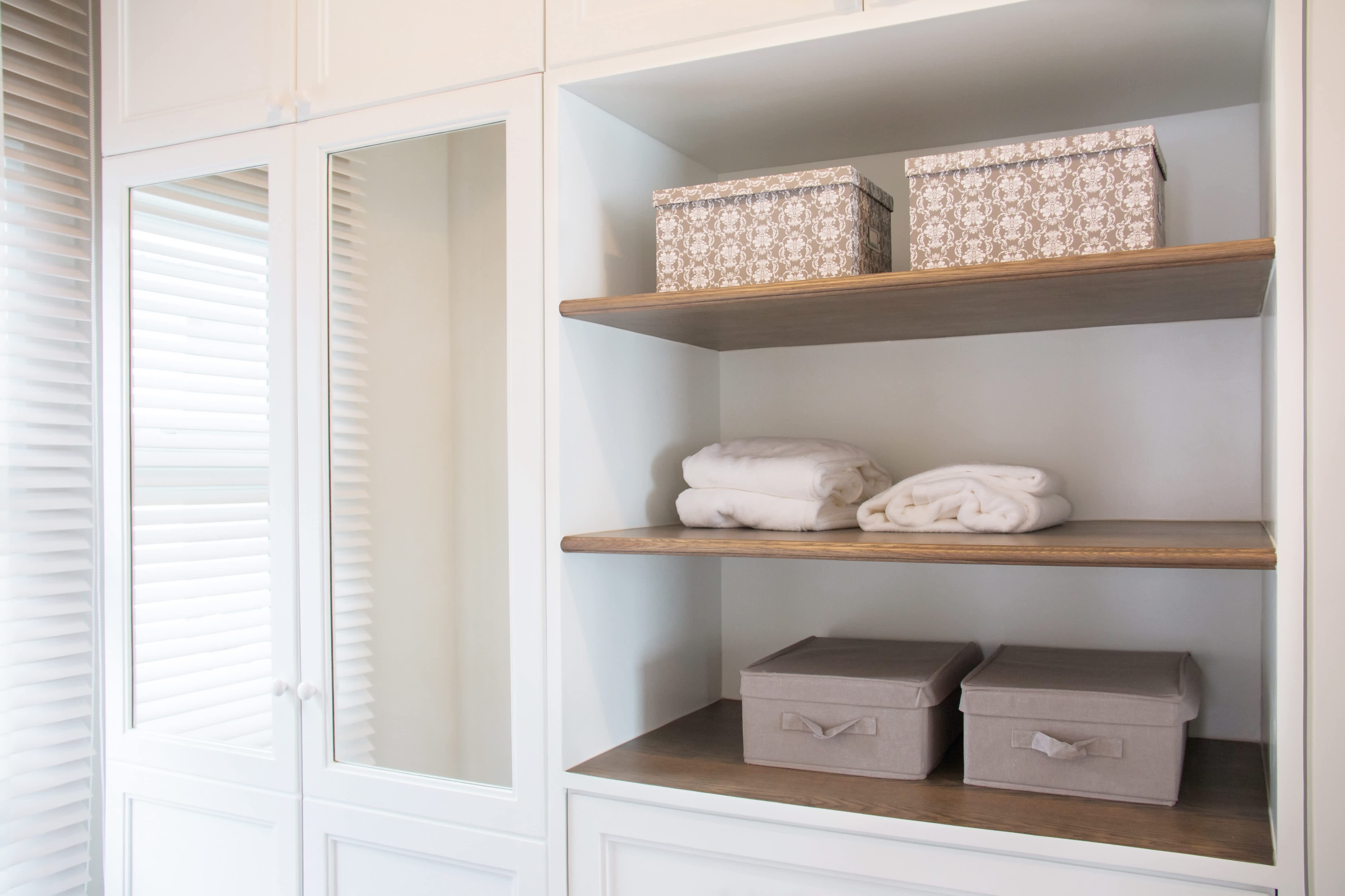 A large closet with built in shelving