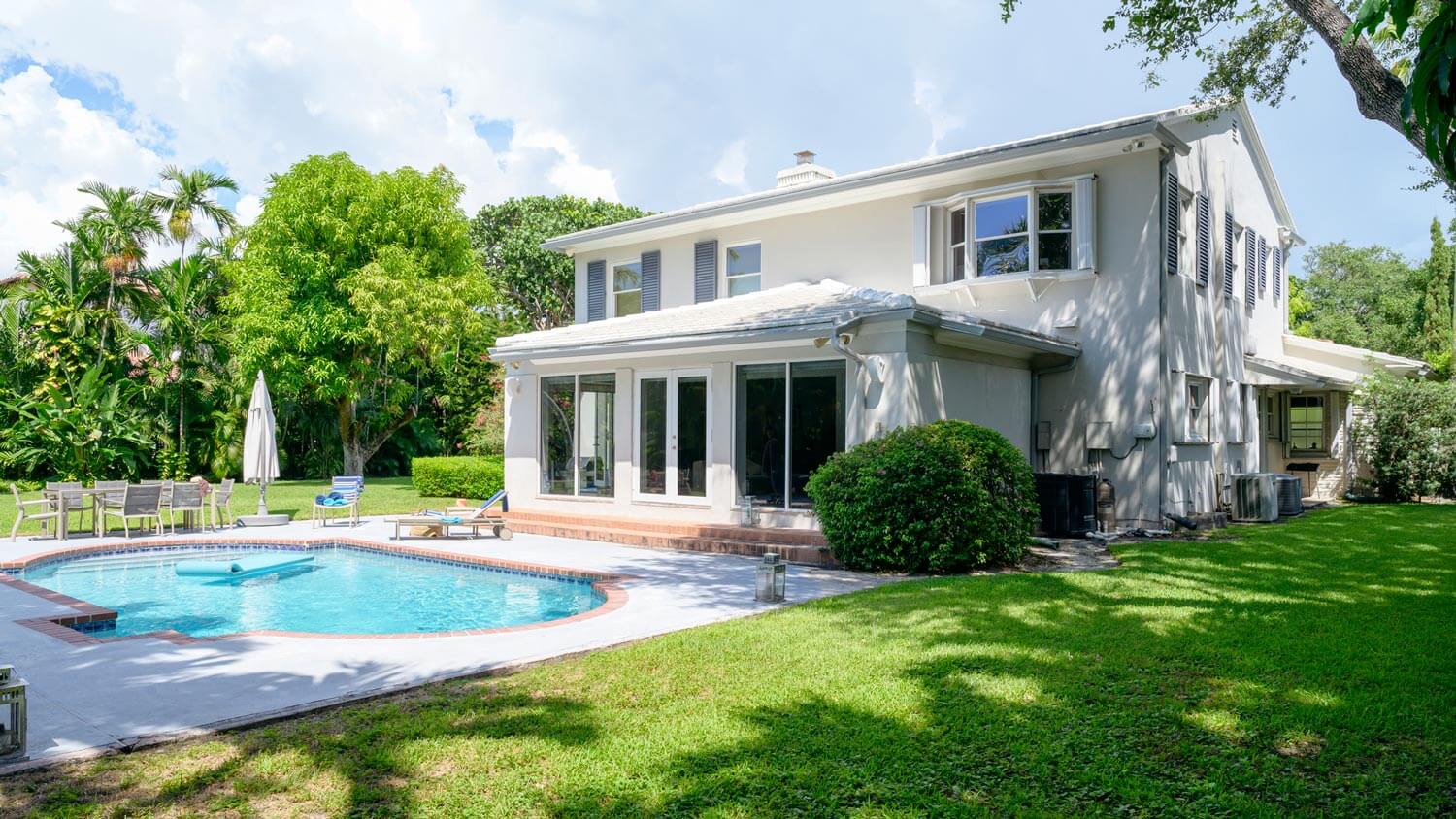 A modern two story house with a swimming pool