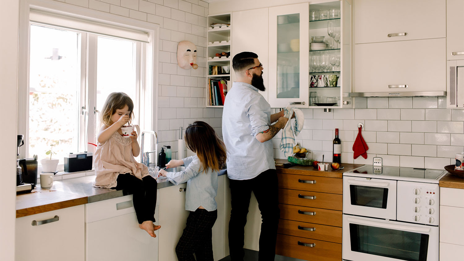 Father and daughter cleaning kitchen