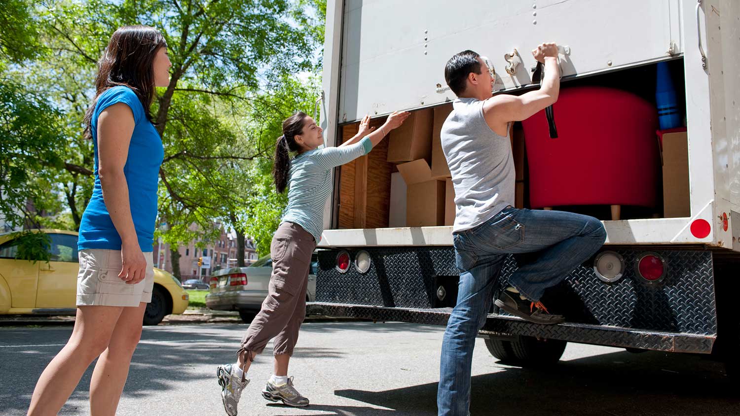 Friends helping to unload moving truck