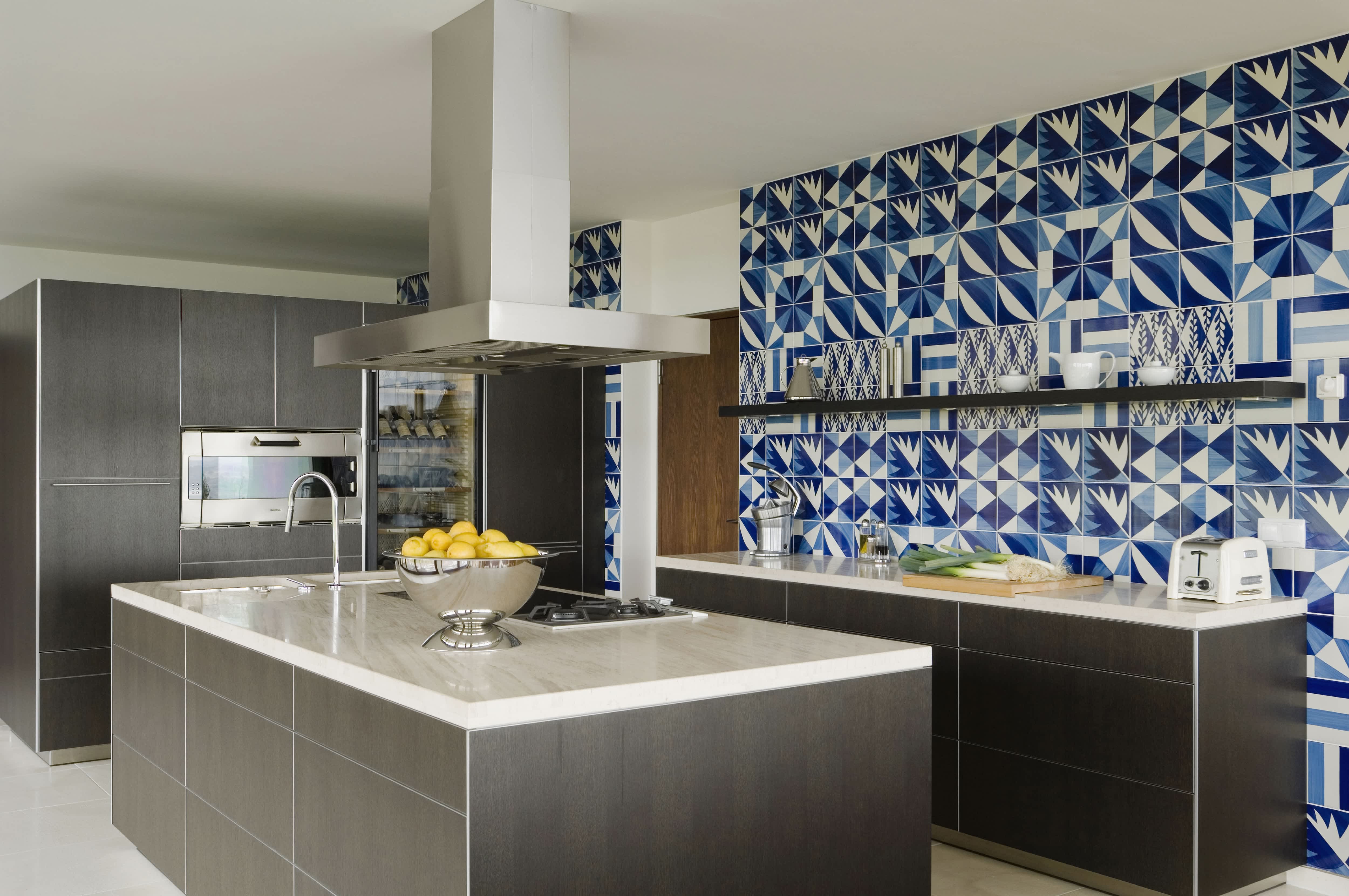 Blue and white kitchen tile backsplash in open layout kitchen