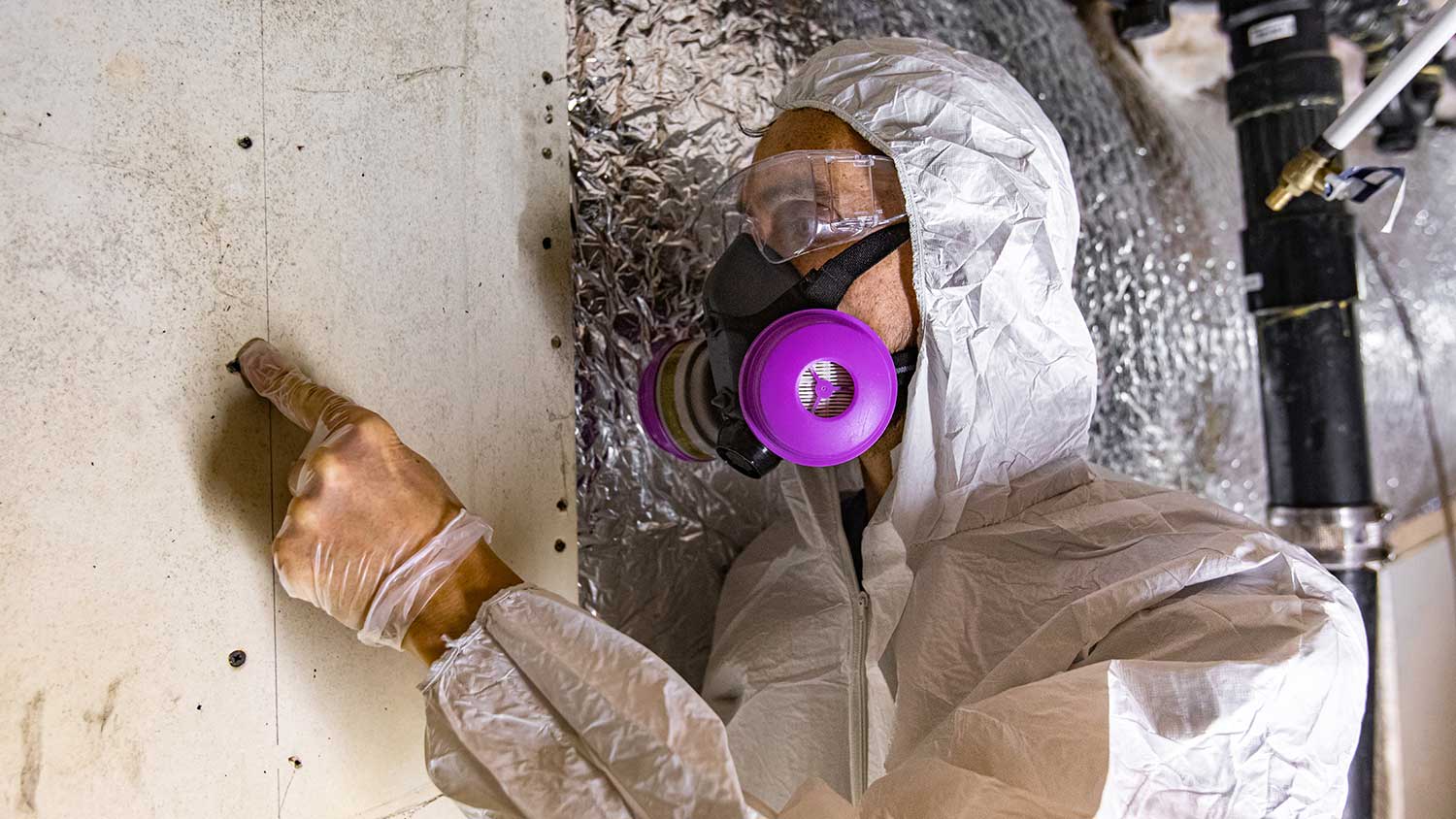 Inspector checking basement walls