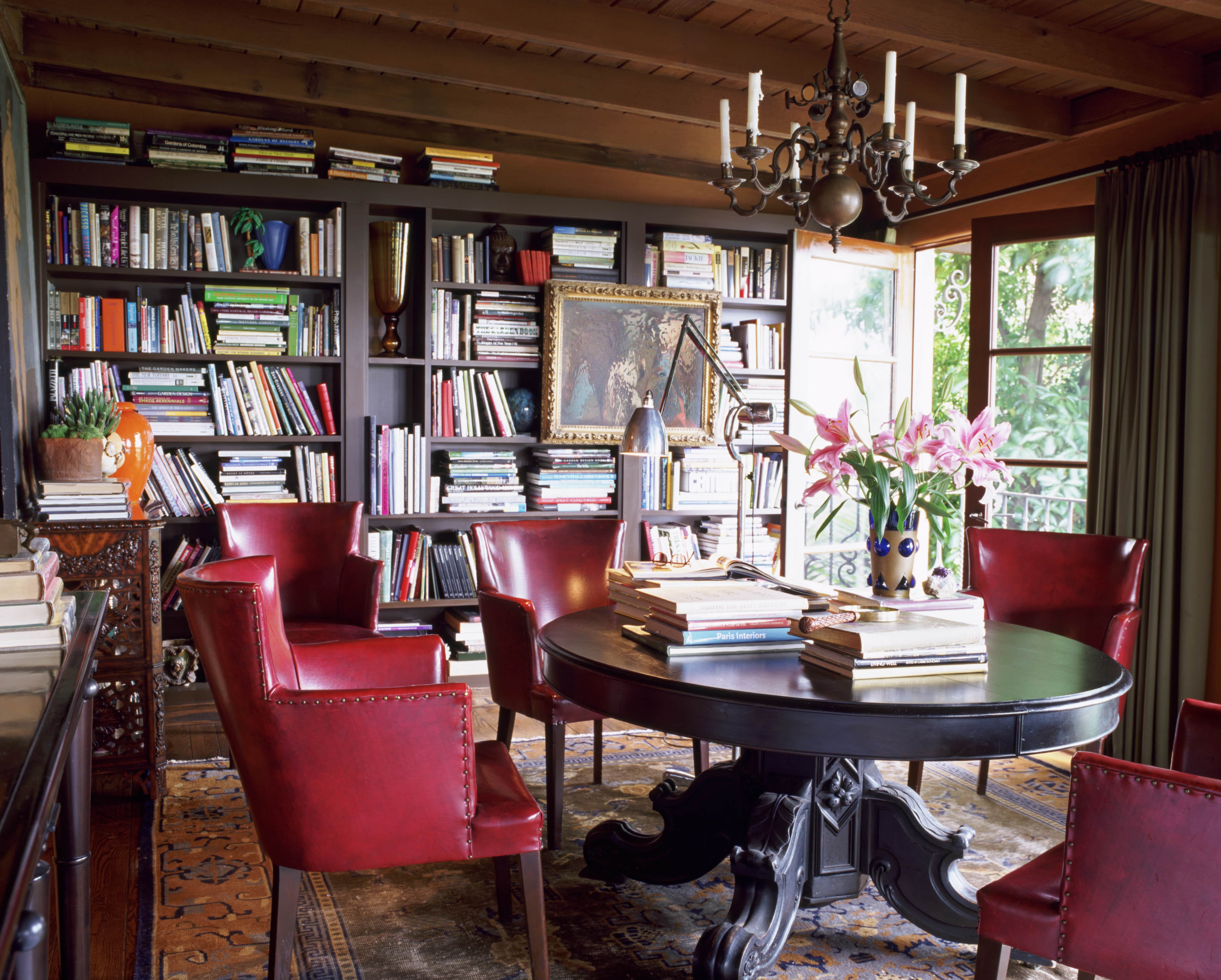 Home library with round Table and red leather chairs