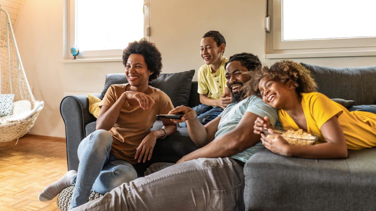 Happy family watching tv together