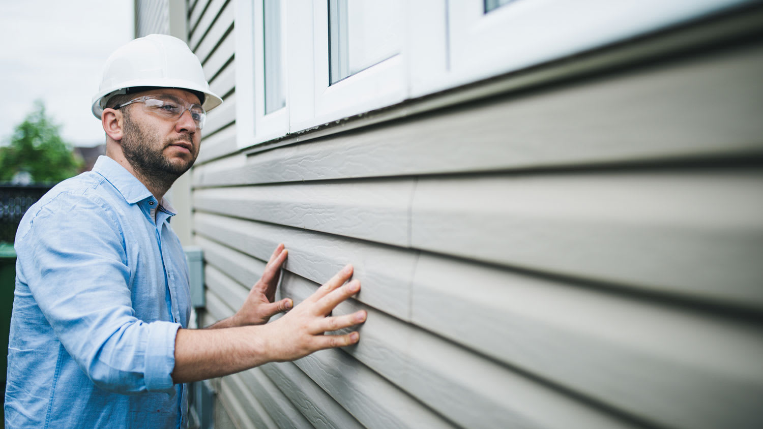 Home inspector checking the windows of a home