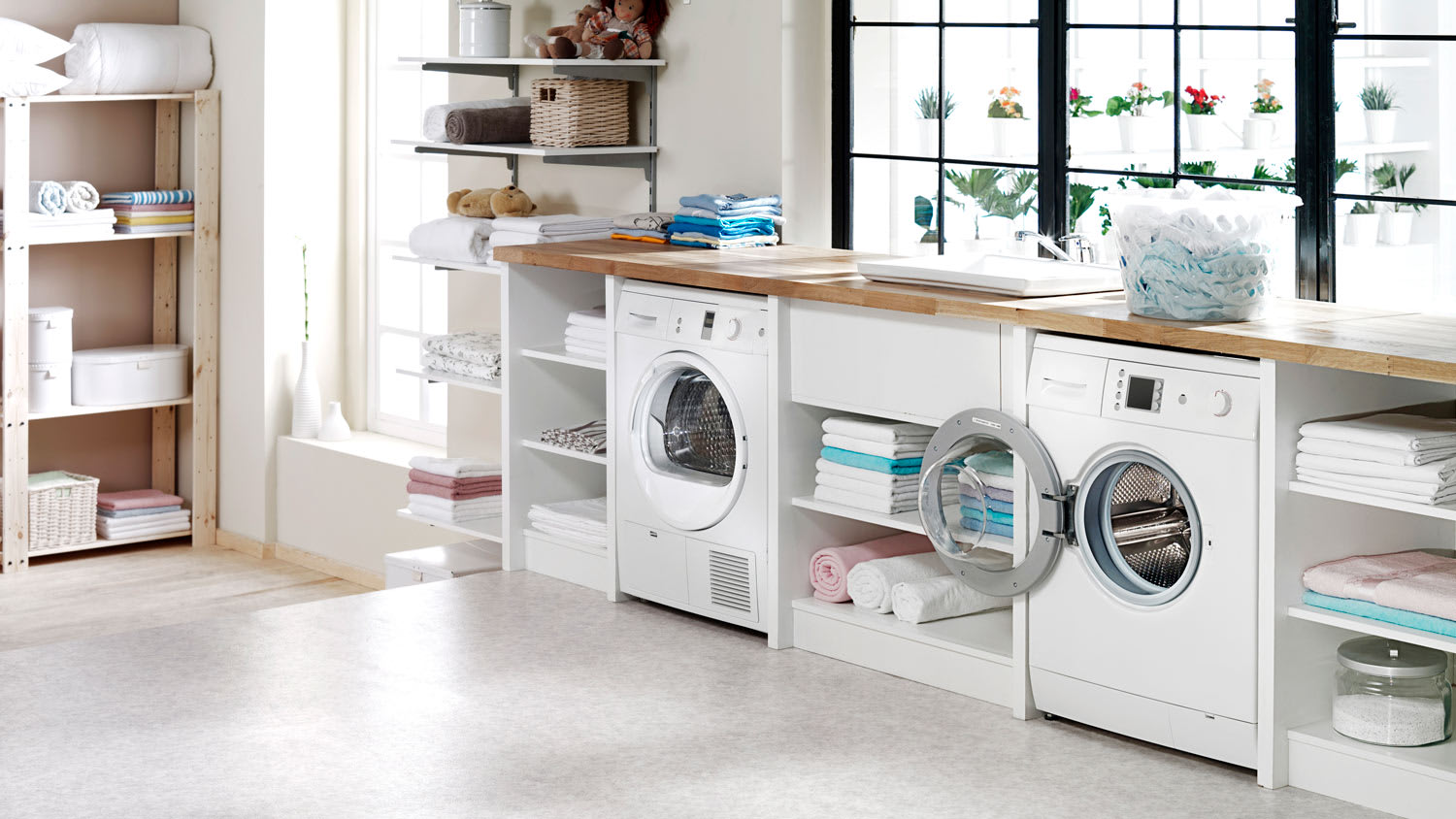 A sunny laundry room with a washing machine and a dryer