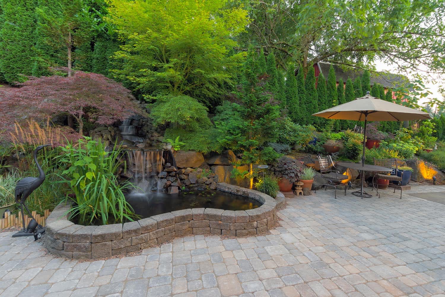Backyard landscaping patio with waterfall pond