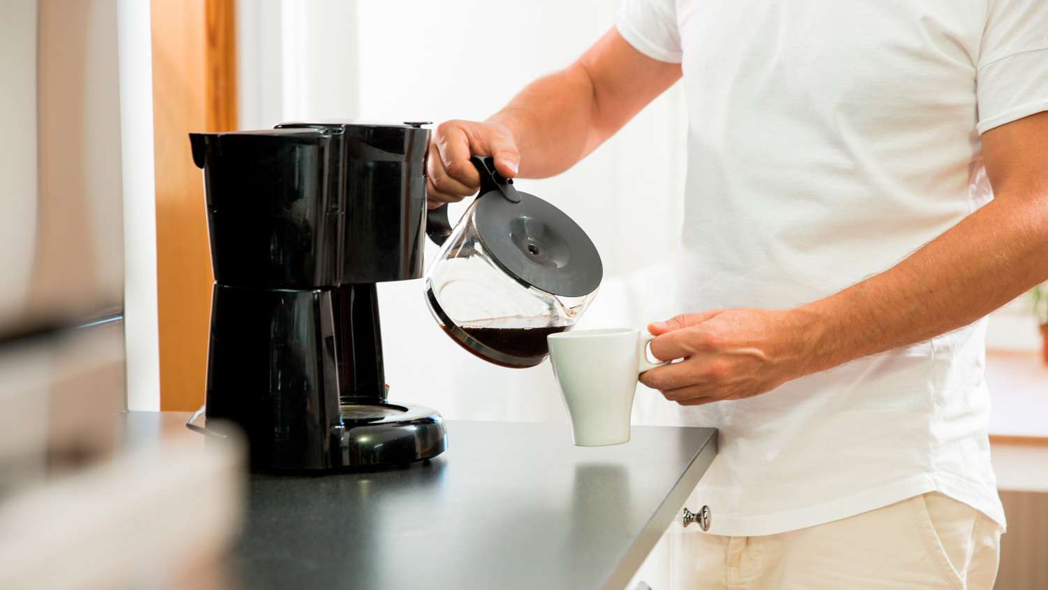 Couple in kitchen making coffee