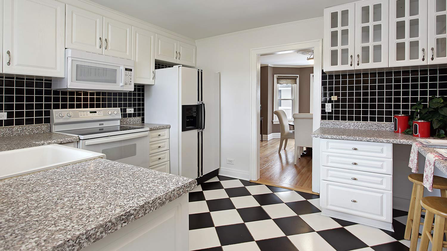 The interior of a kitchen with linoleum flooring