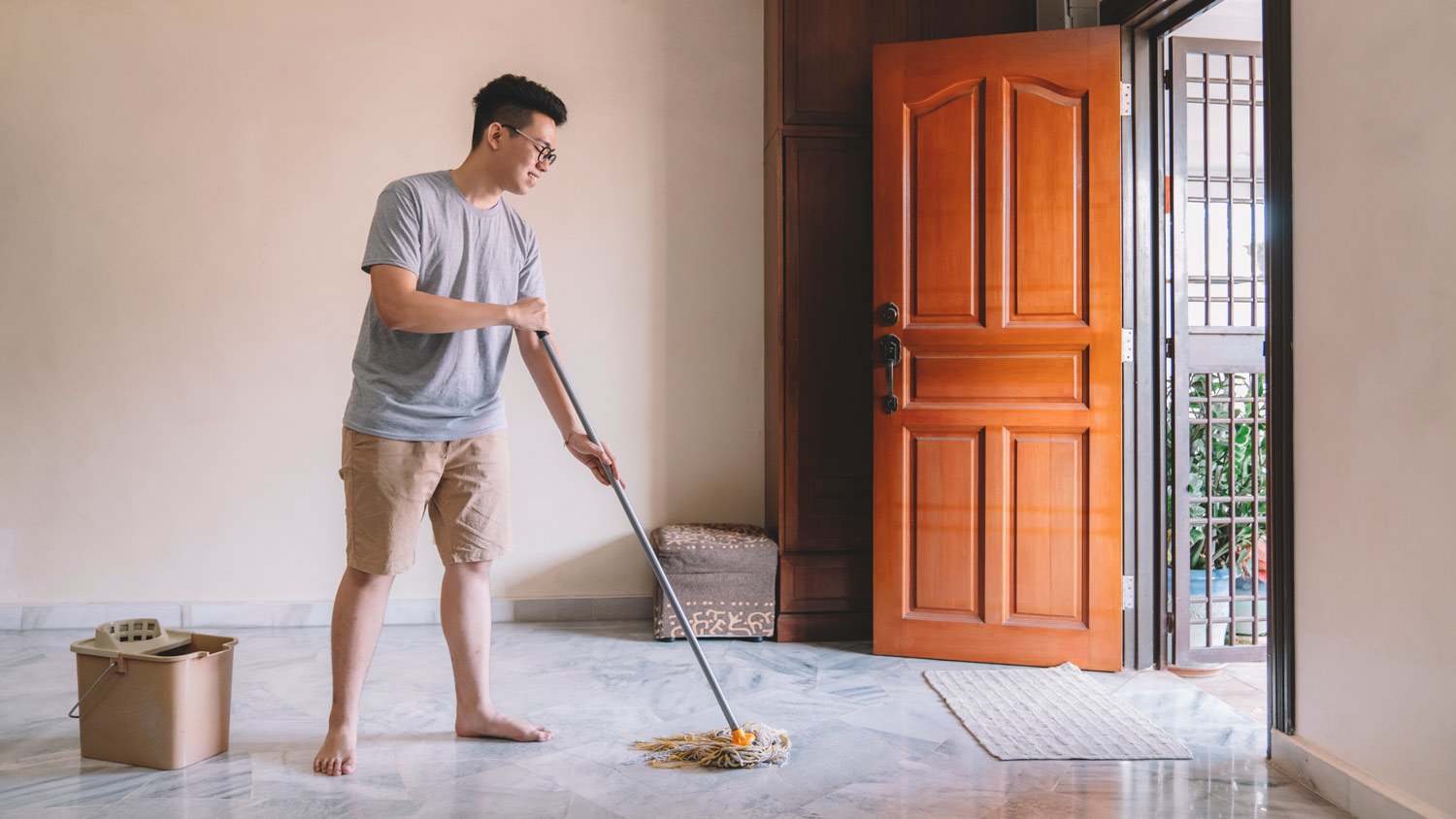 A man mopping a marble floor