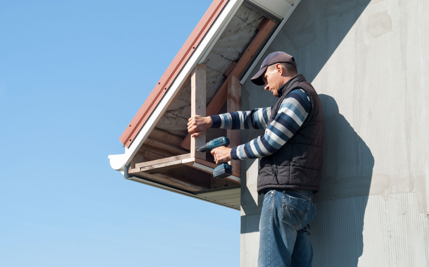 Metal house roof with soffit boards