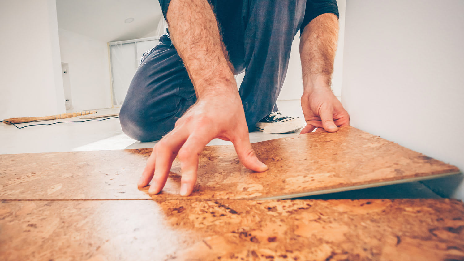 A professional installing new cork floor
