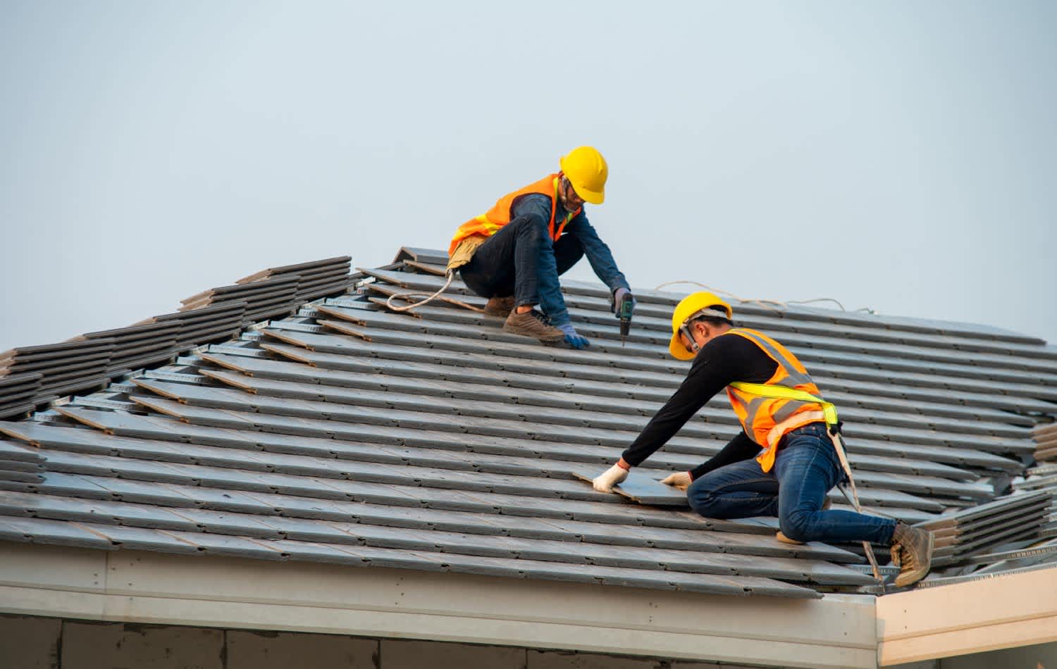 Two workers replacing the roof