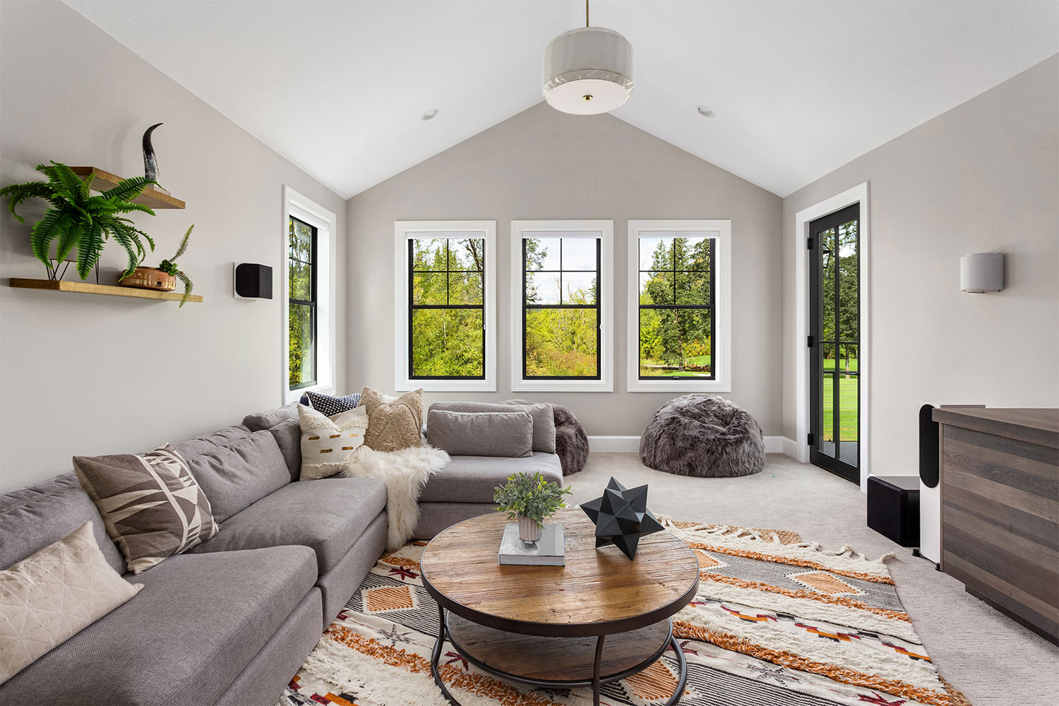 living room with area rug over carper