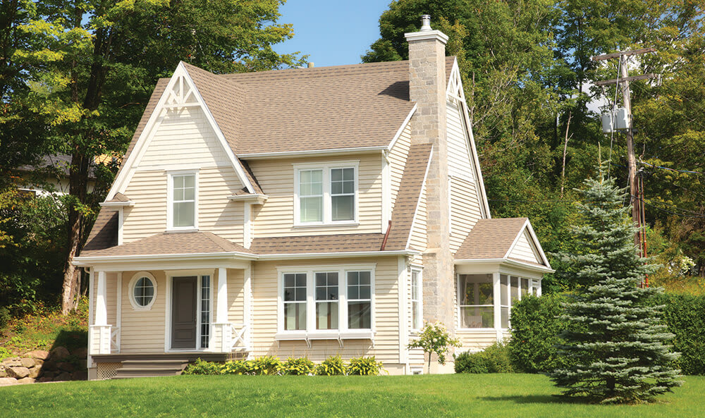 Cottage home with a peaked, shingle roof
