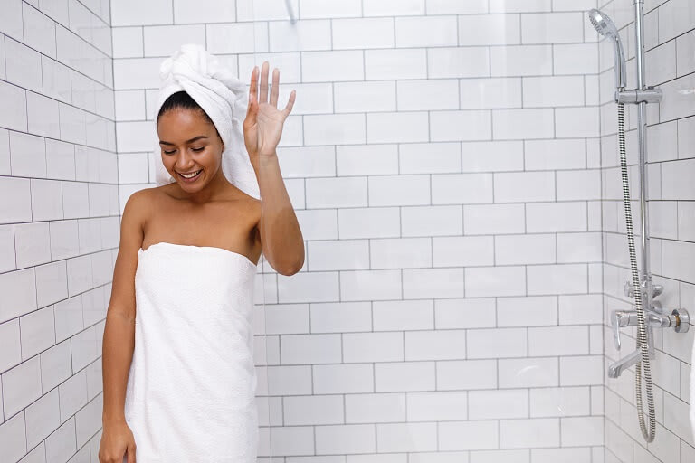 woman in towel walks out of newly converted stand-up shower