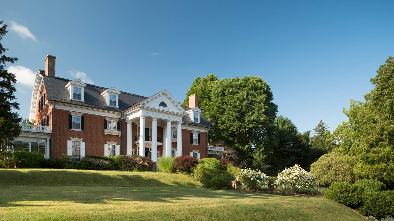 The facade of a an early 20th century grand mansion