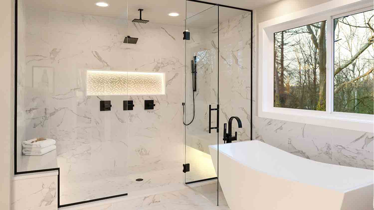 black and marble bathroom with soaking tub