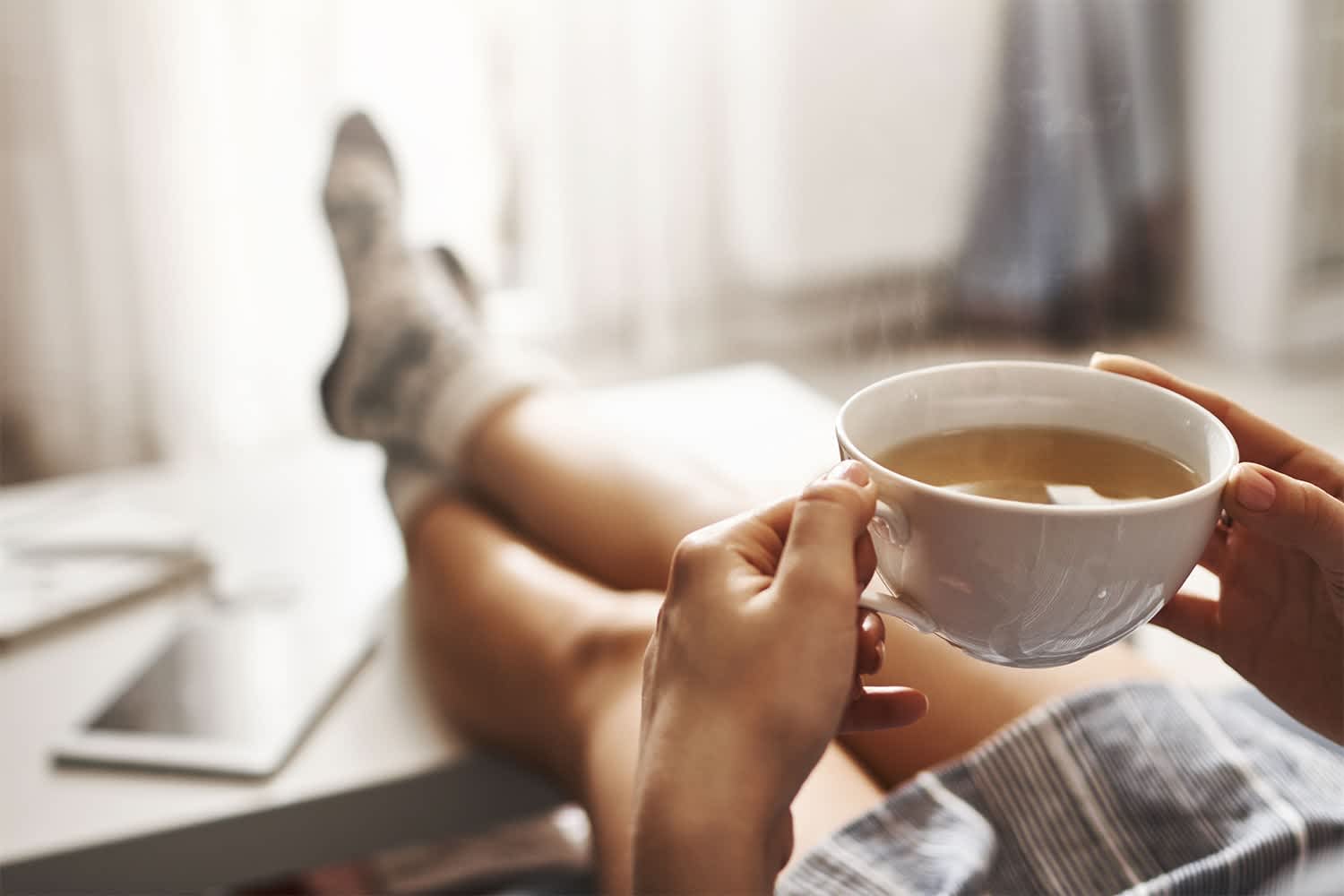 Woman using coffee machine on pull-out shelf