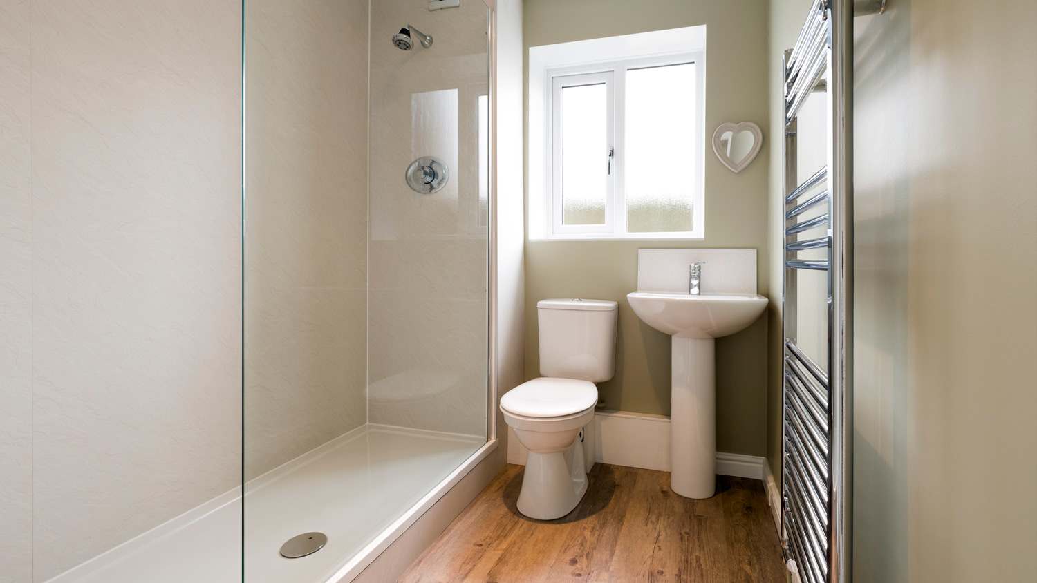A modern compact bathroom with a shower and a toilet