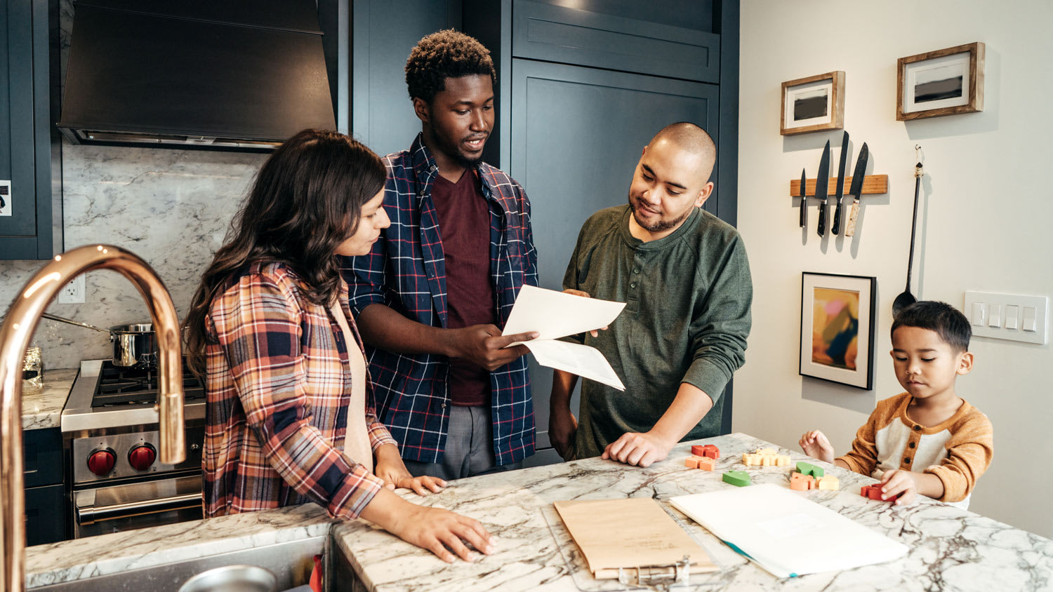A family and a contractor talking in kitchen