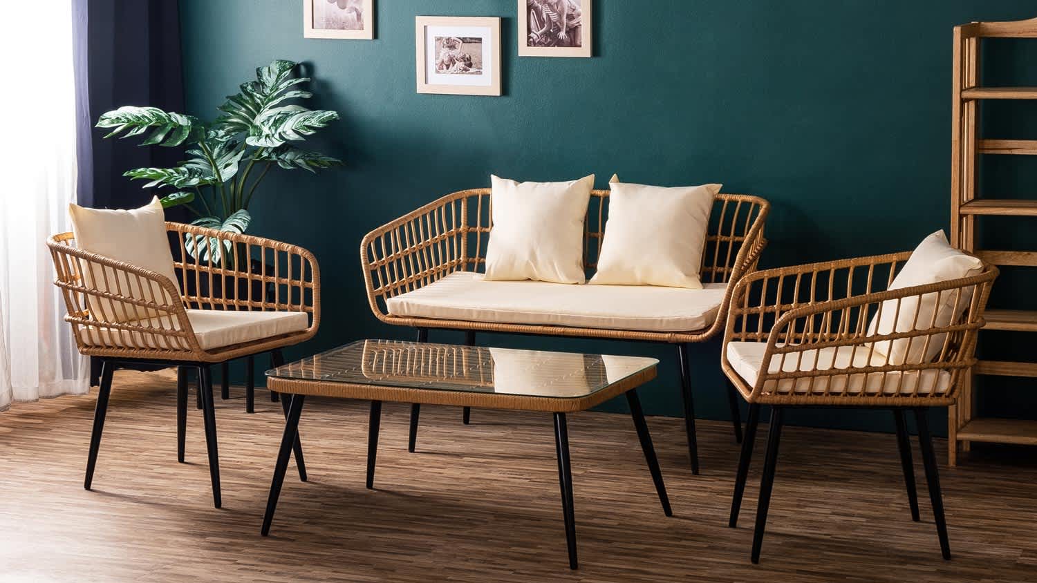 A dark green painted lounge area with bamboo furniture