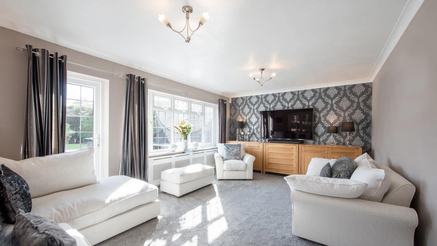 A bright living room with a gray carpet