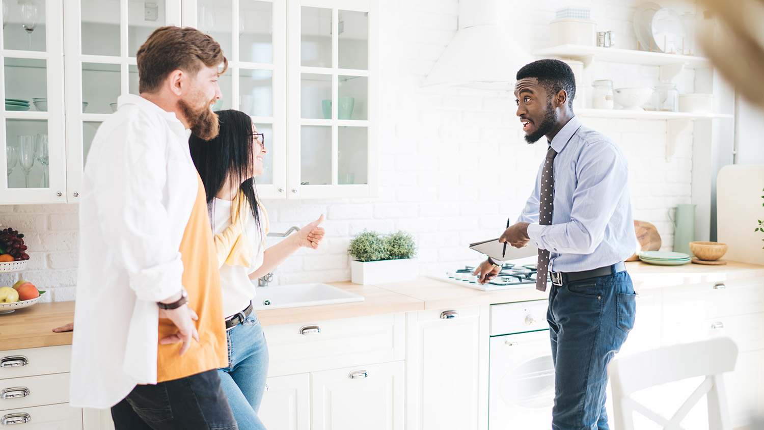 Home inspector looks over house with potential homebuyers