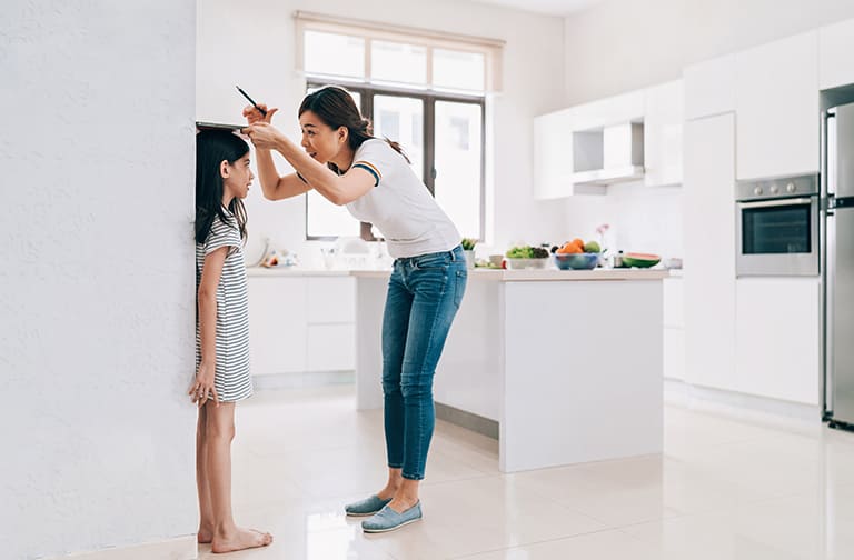 Measuring height of child on a big wall, open concept kitchen