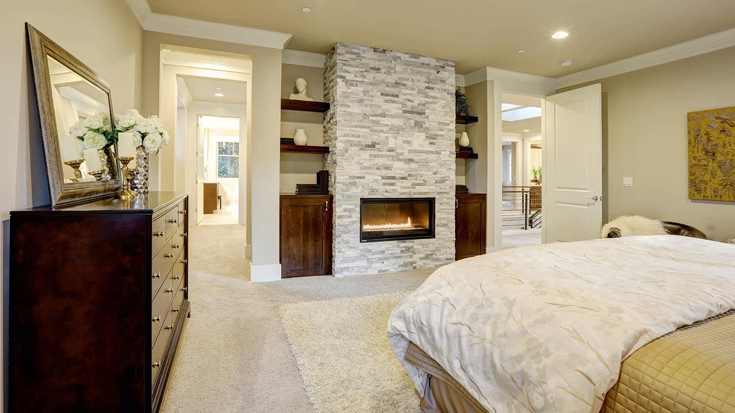 A stone fireplace with bookshelves built in on both sides