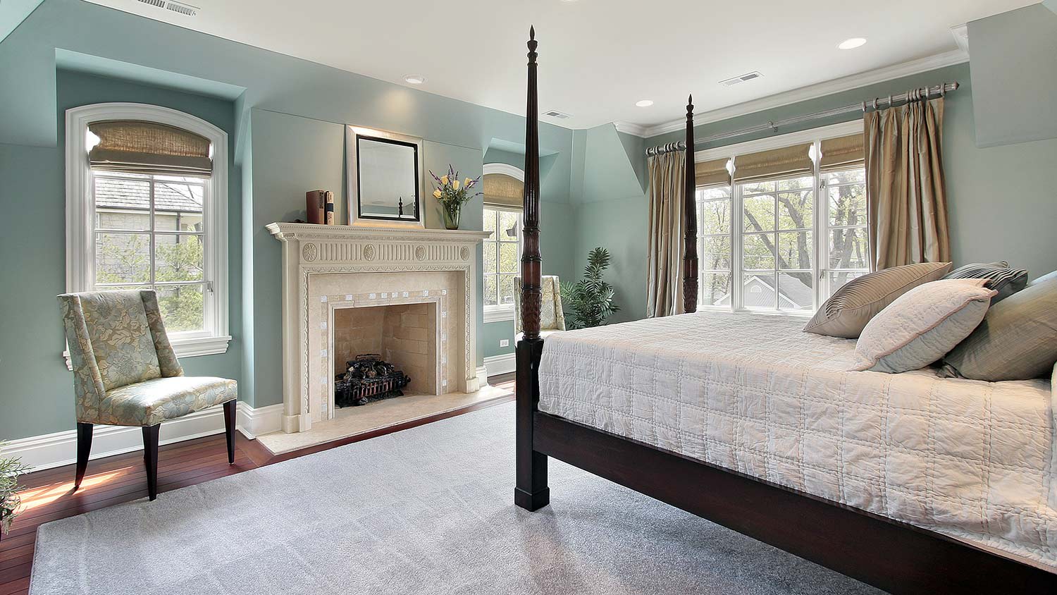 Master bedroom with stunning fireplace and four poster bed