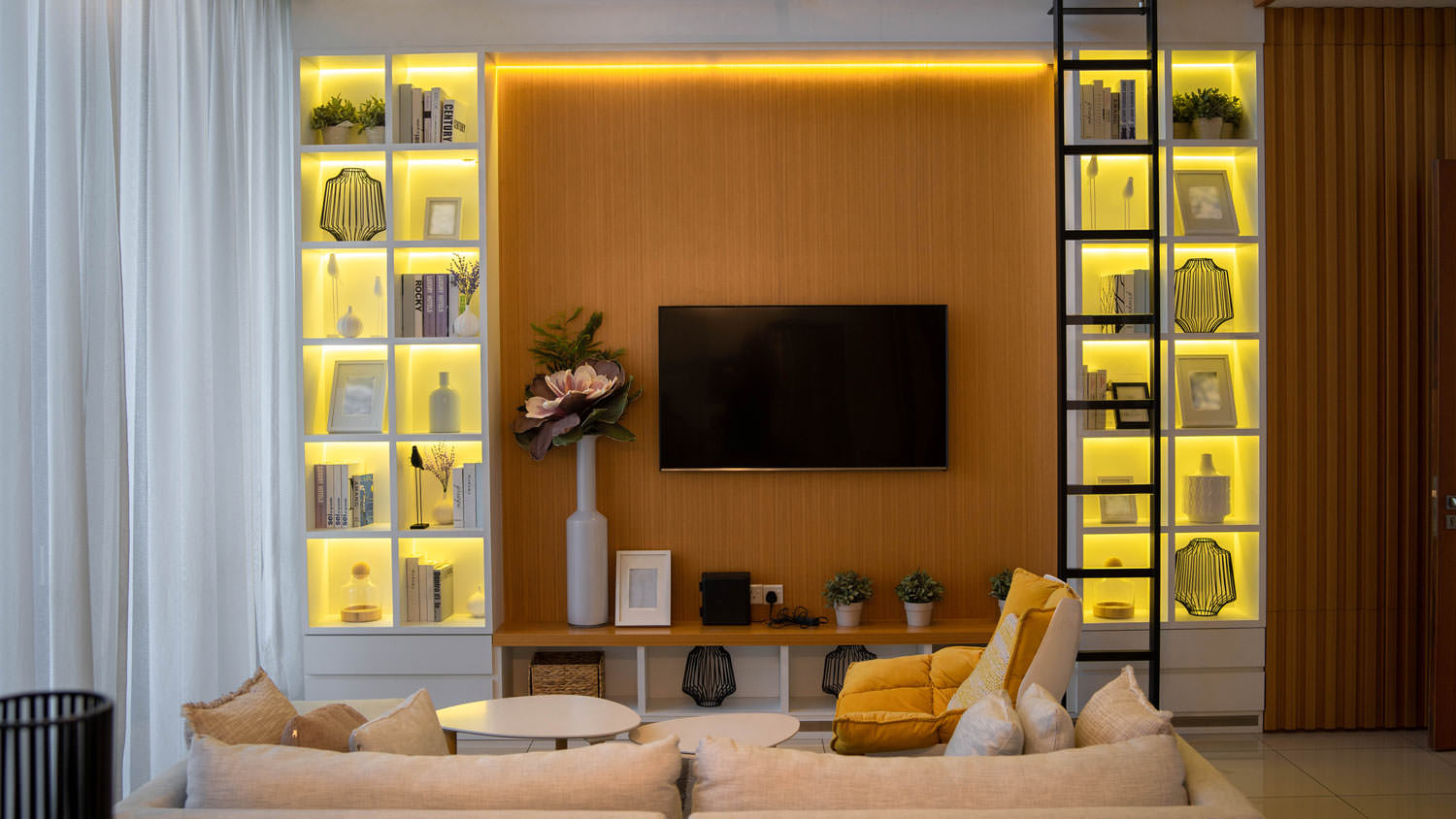 A modern living room with bookcase and a TV set