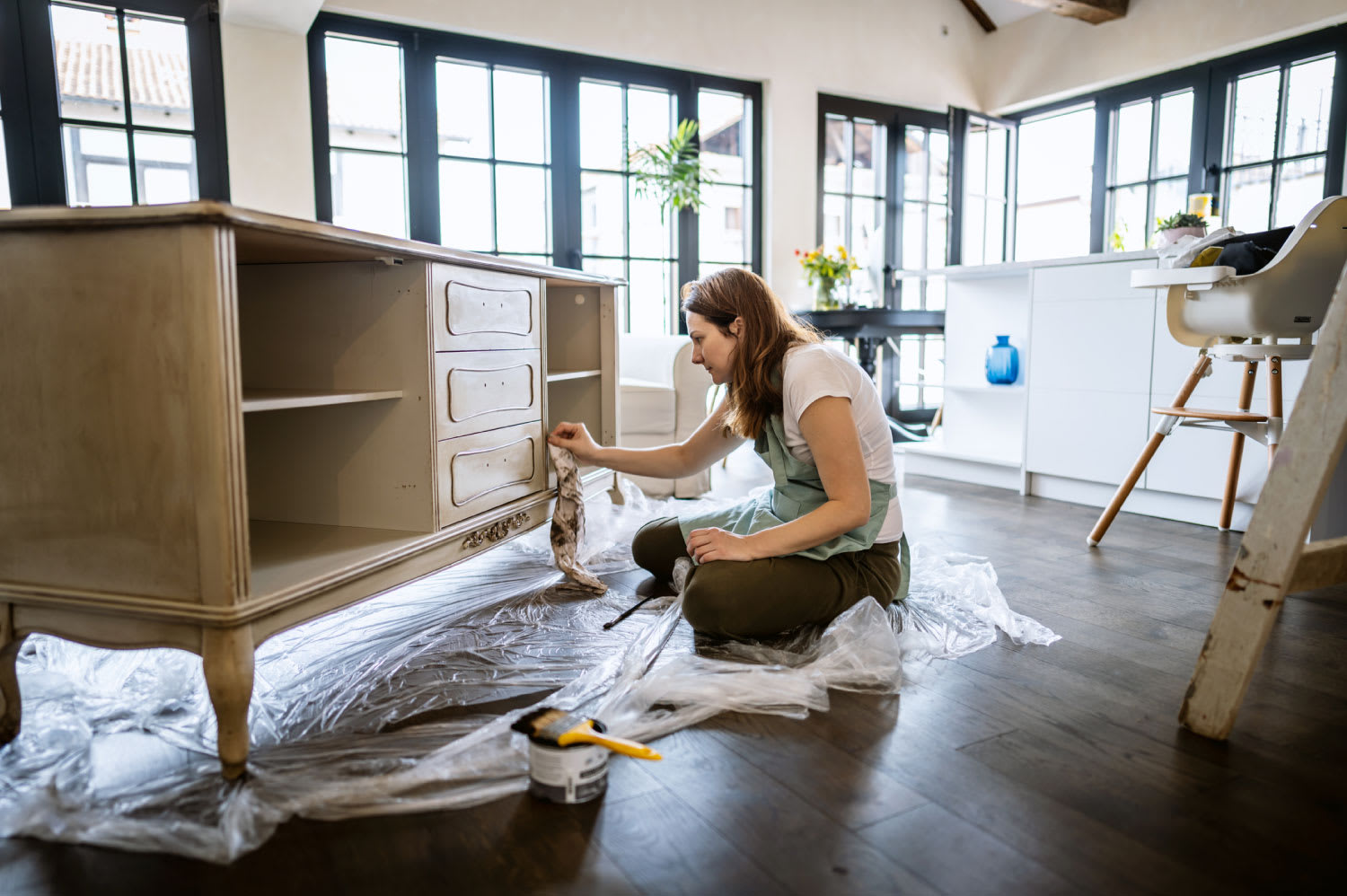 Woman repairing an old furniture