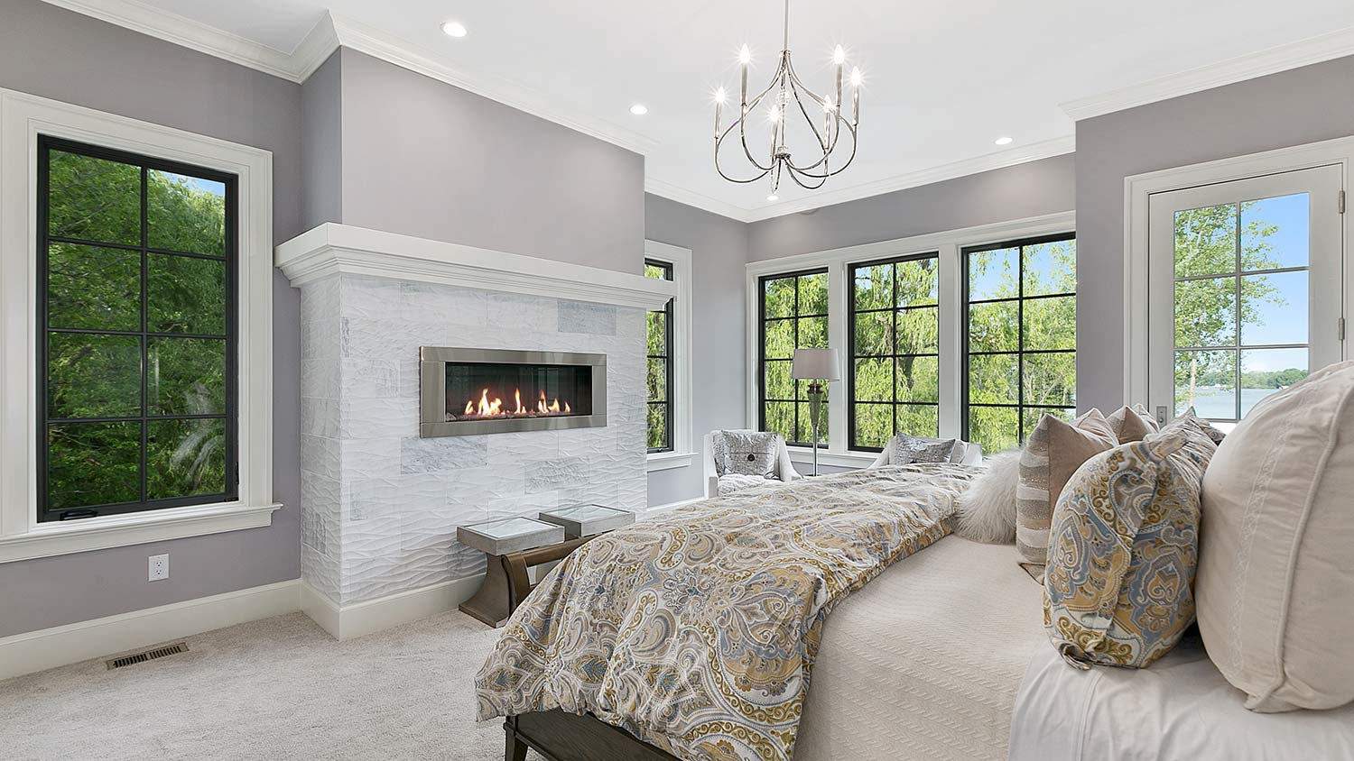 Bedroom fireplace with art sitting on the mantle.