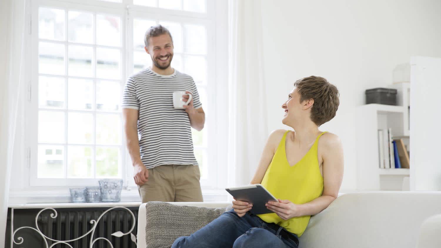 Happy young couple in living room at home