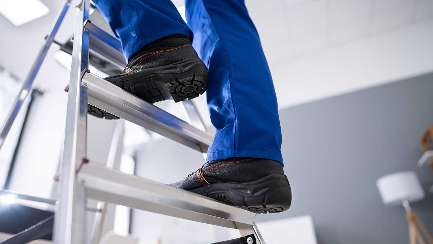 Man climbing ladder at home