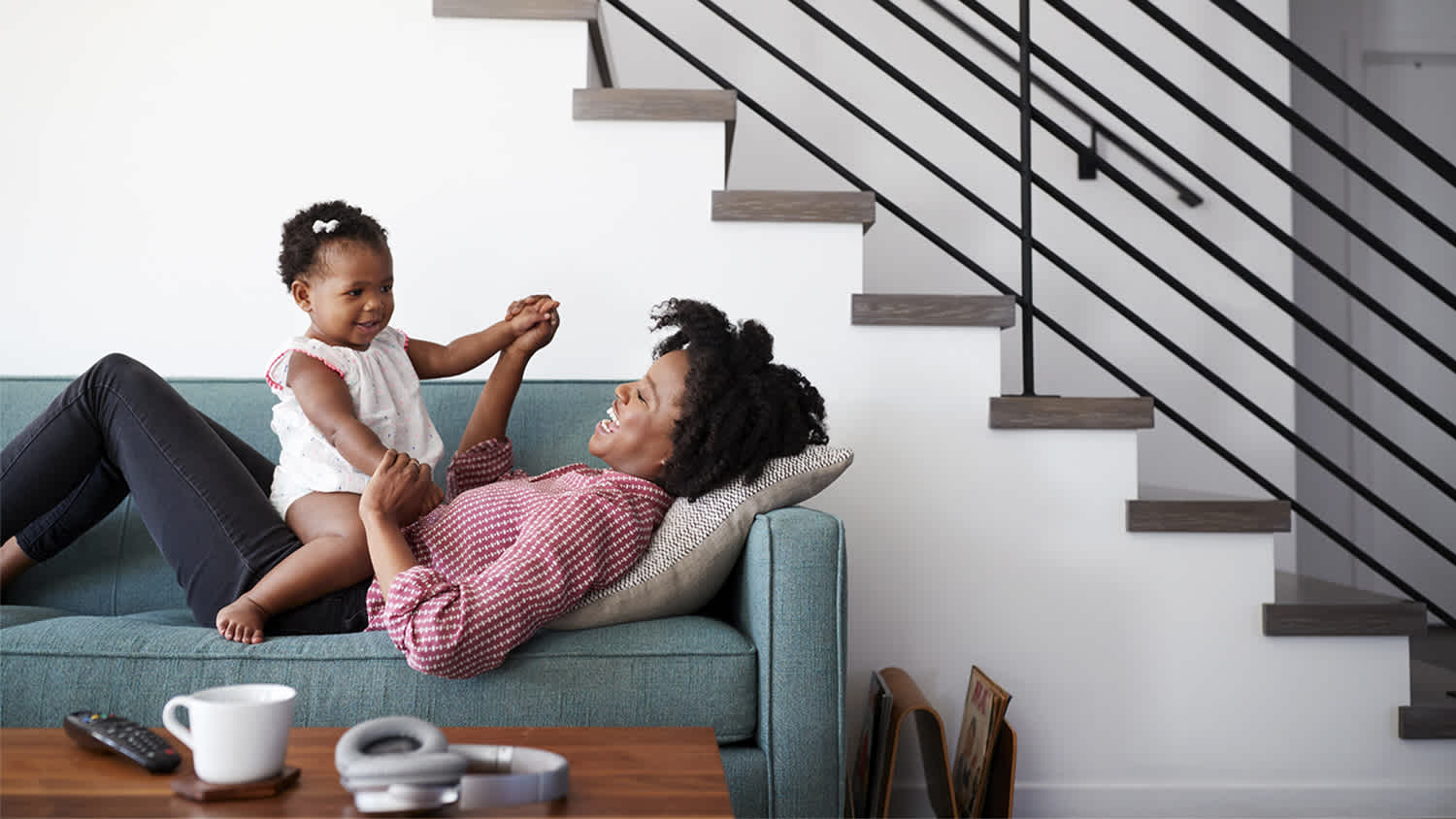 mom and baby playing on couch