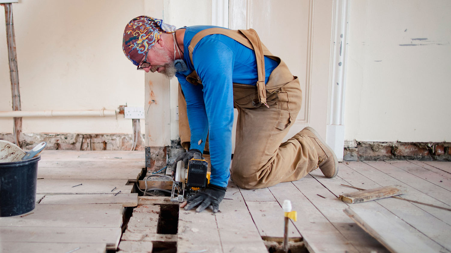 Man replacing floor in house