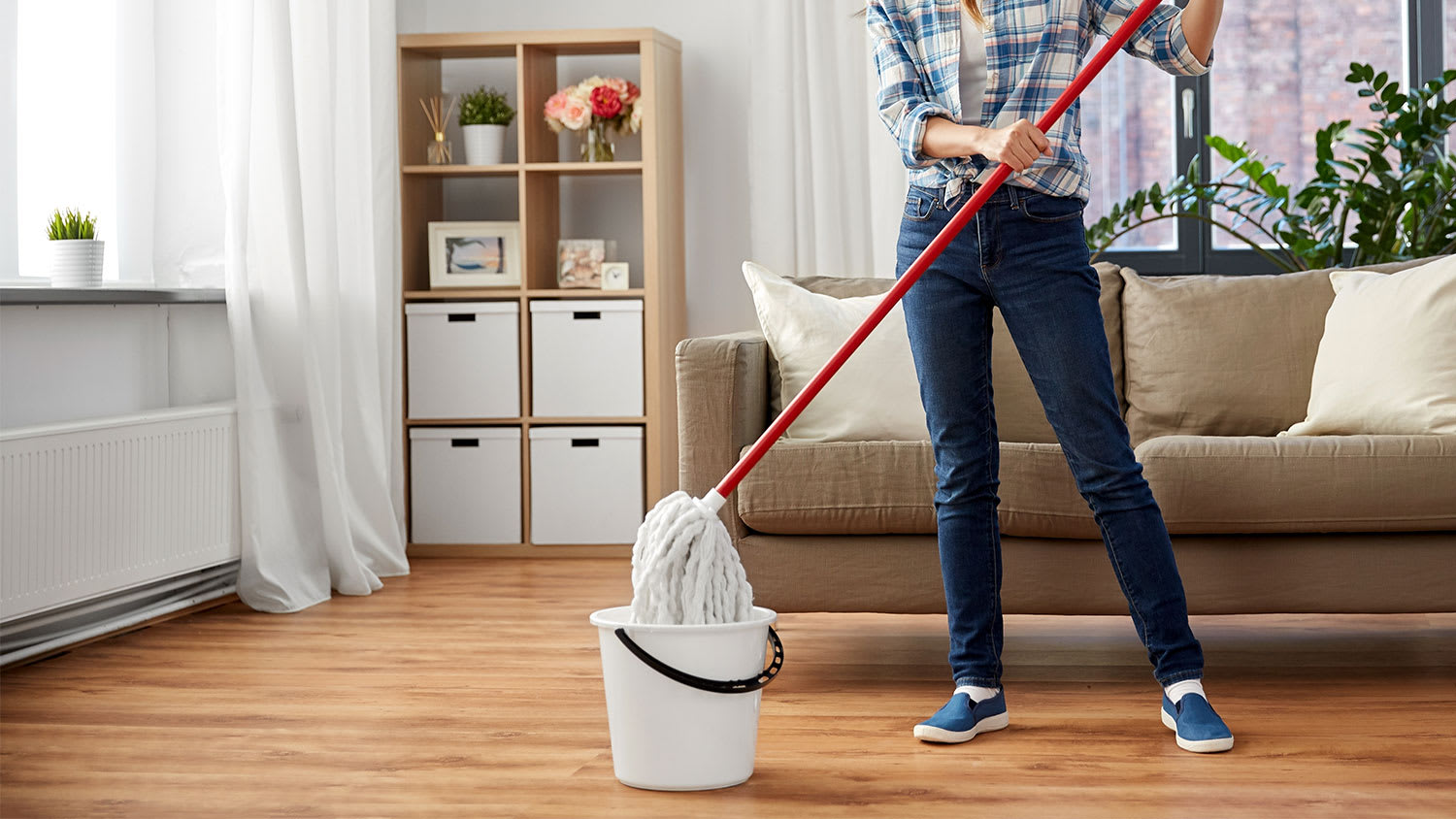 woman is dunking a mop in a bucket