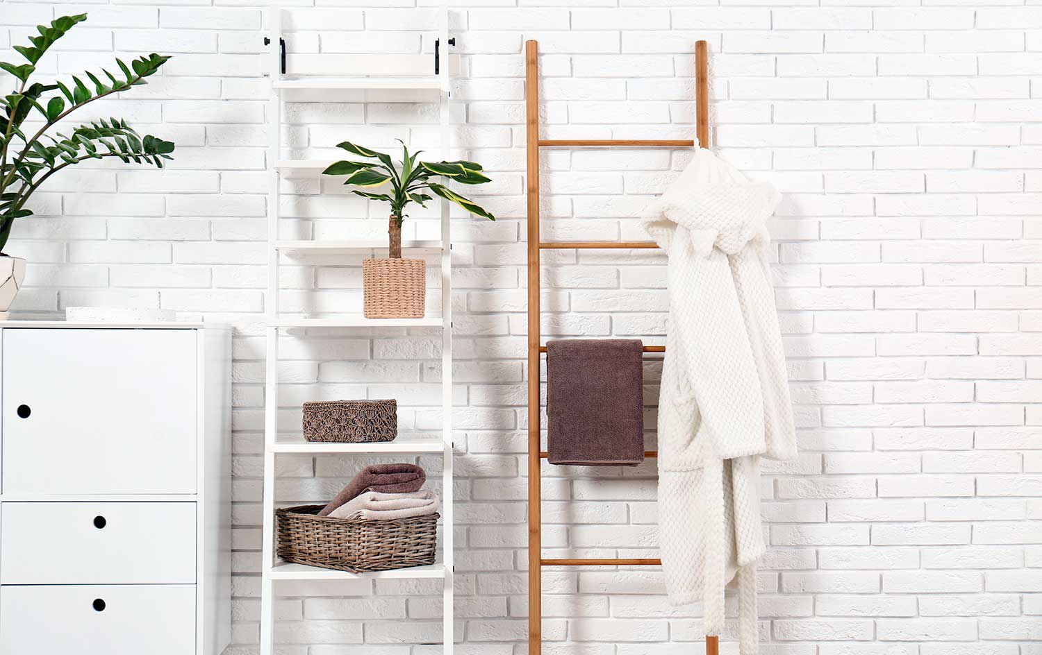 Wooden ladder with towels in white bright bathroom