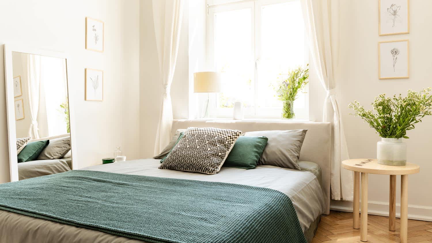 Bedroom interior with big bed and a sunny window
