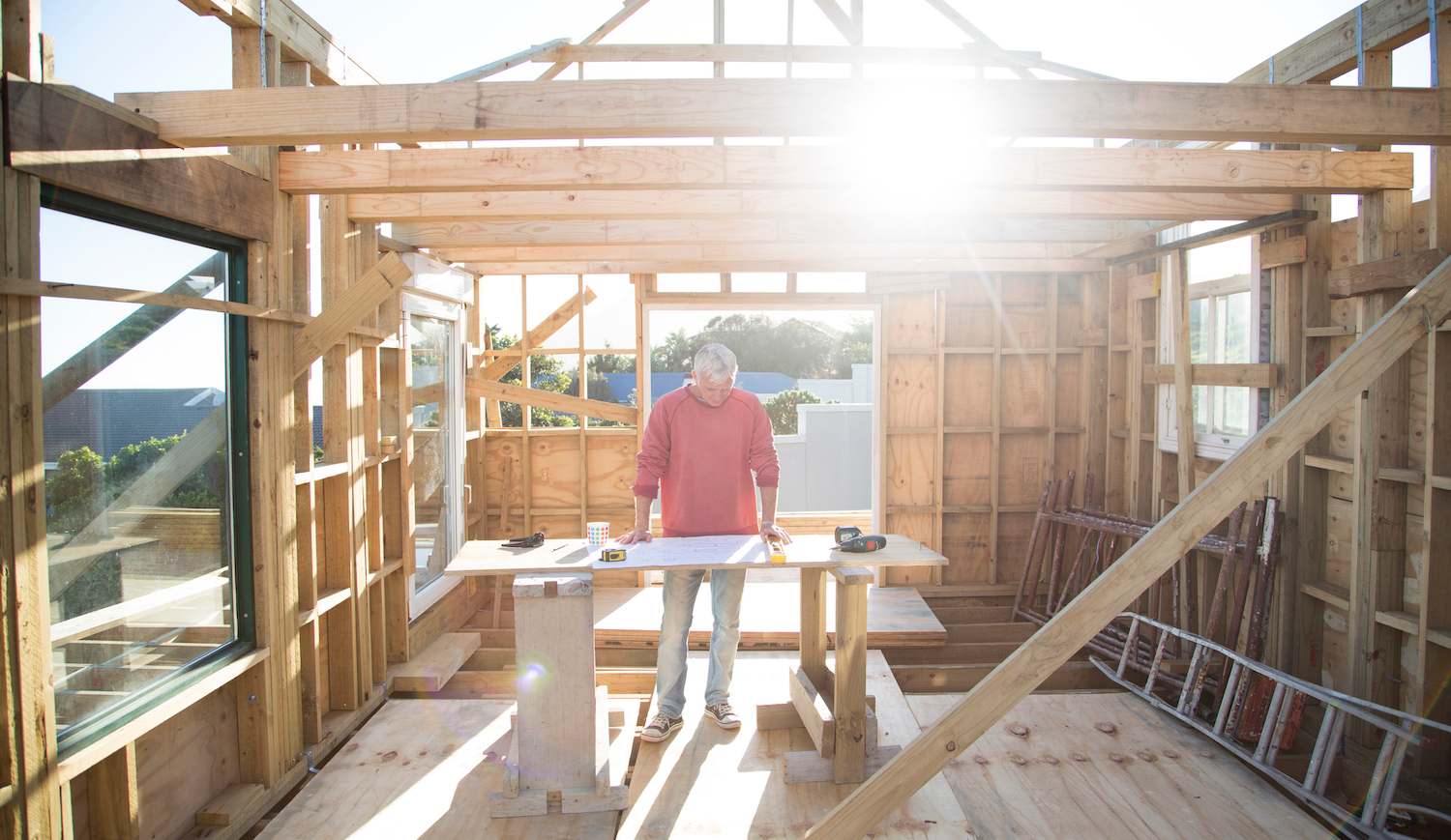 contractor stands at work table in a new house being built