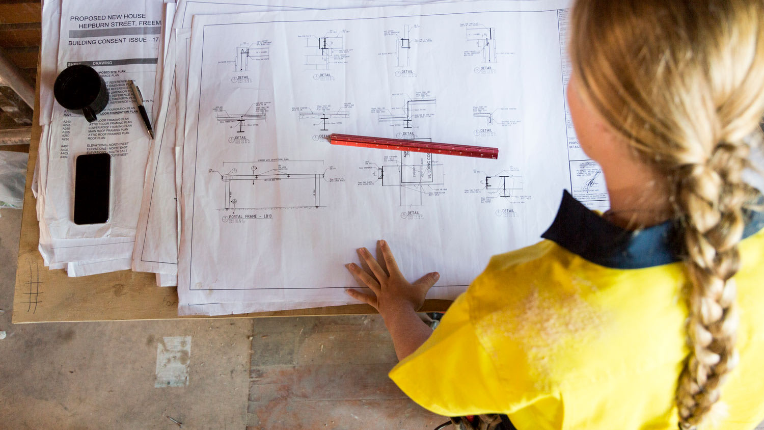 A female contractor looking at site plans