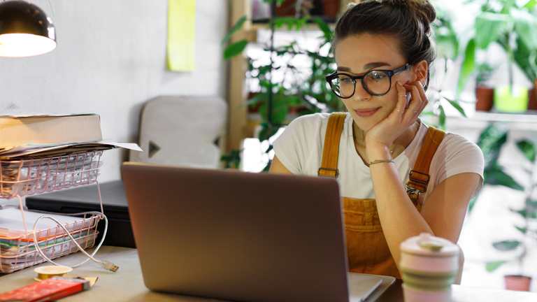 Woman at laptop writing a review