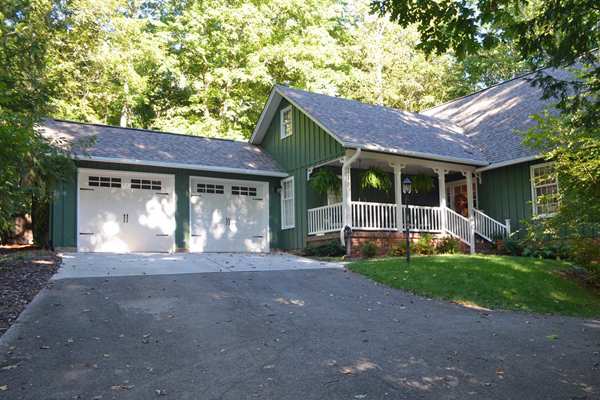 green house with carriage garage doors