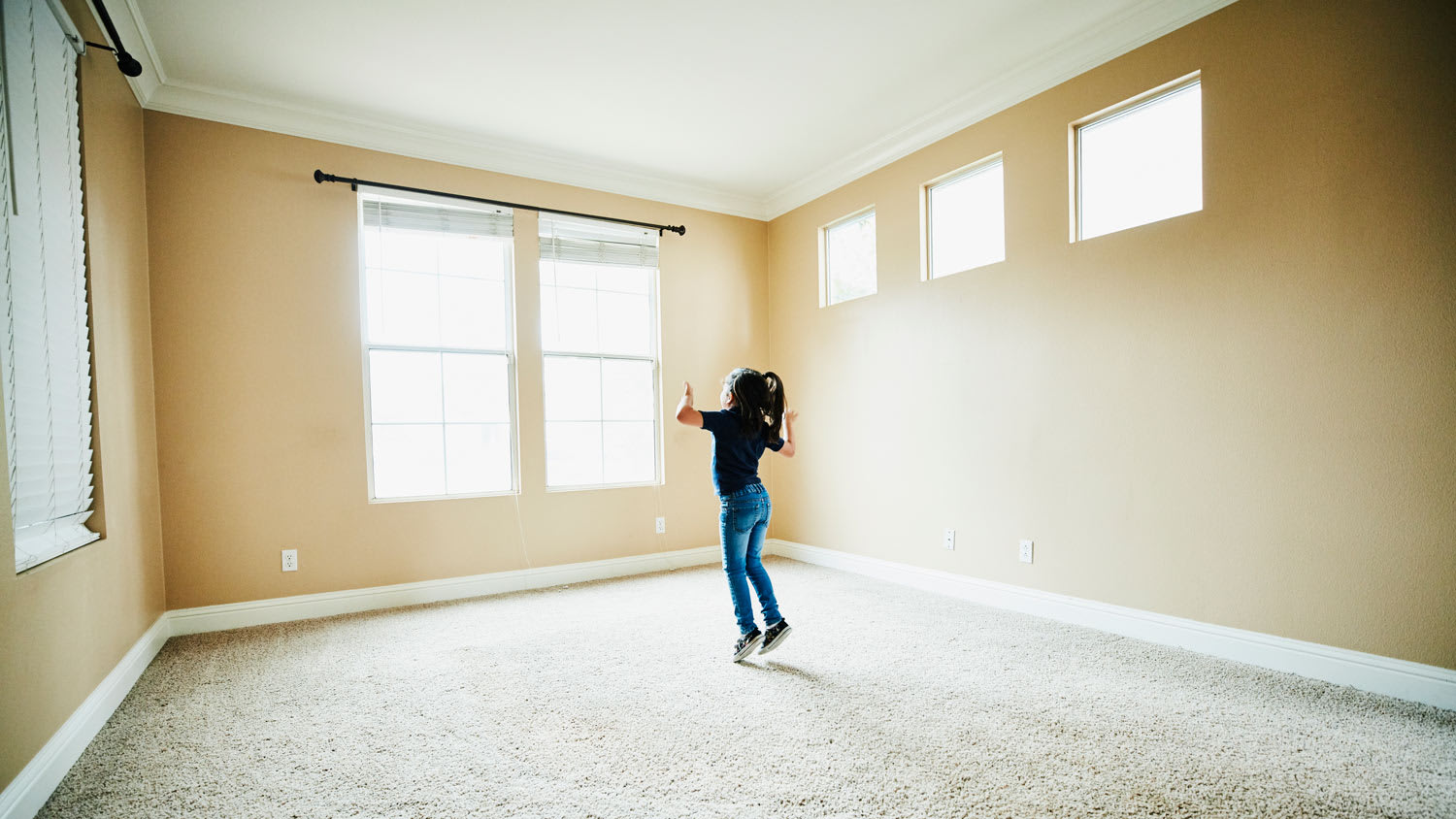 A young girl dancing in an empty room