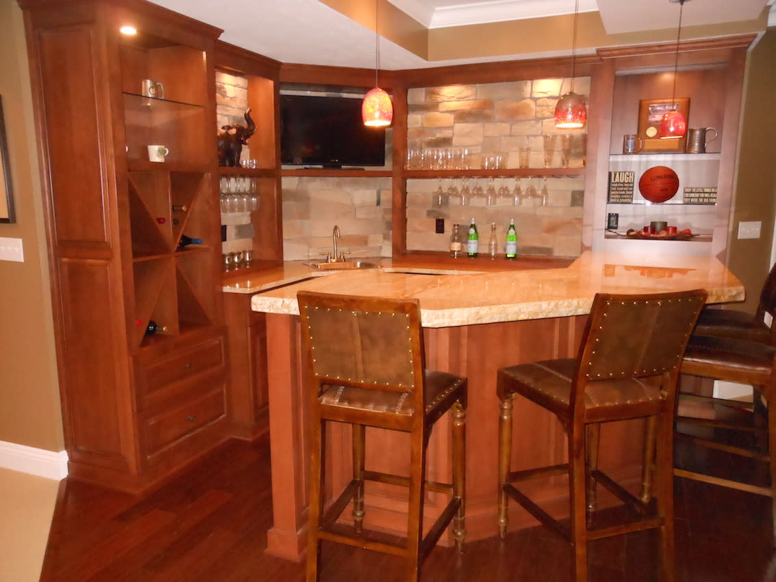Wet bar with wood cabinetry